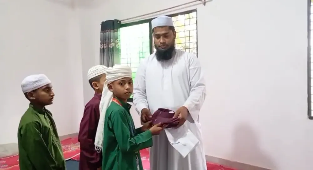 A teacher blessing a student at the campus